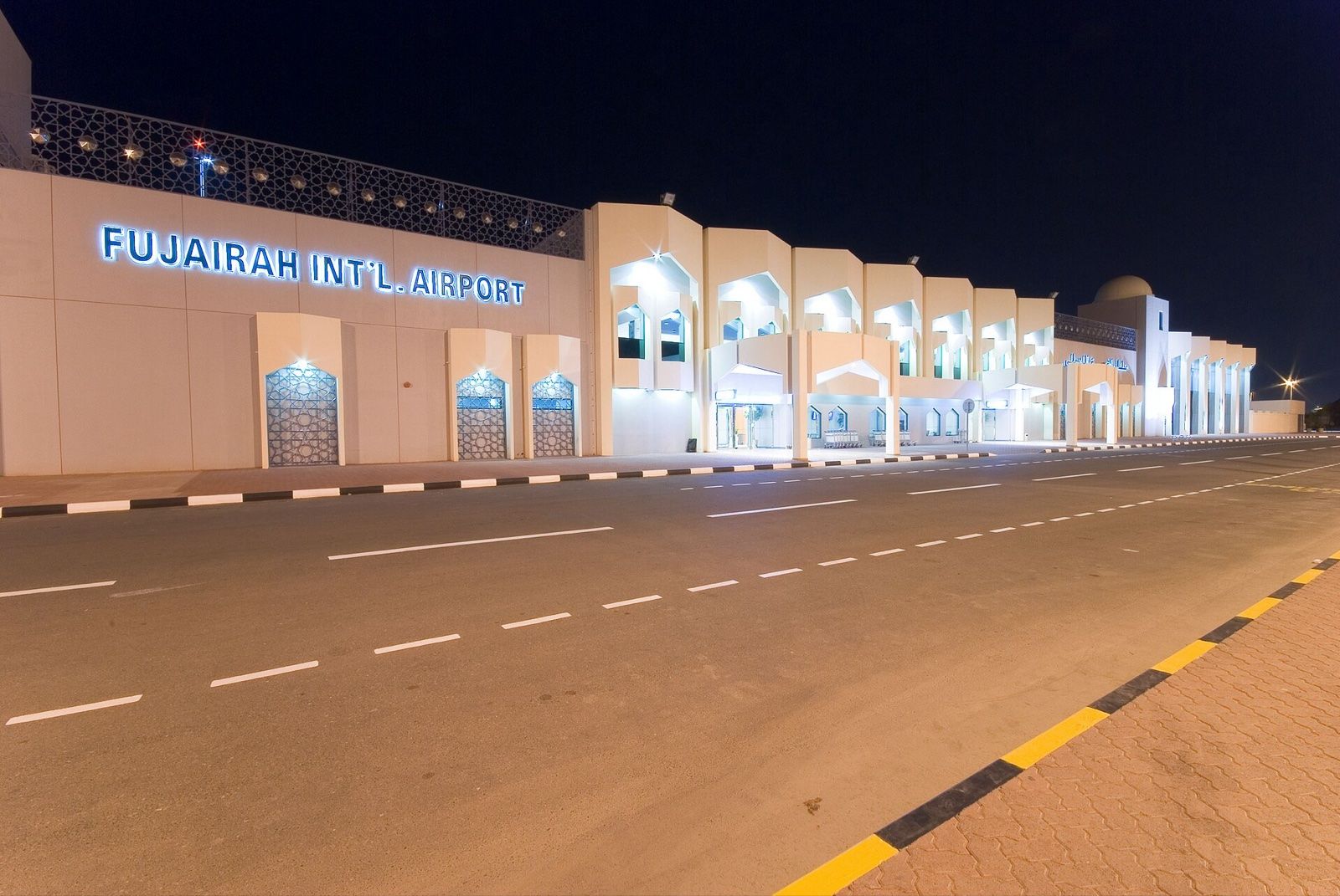 Fujairah International Airport terminal building and access road lit at night