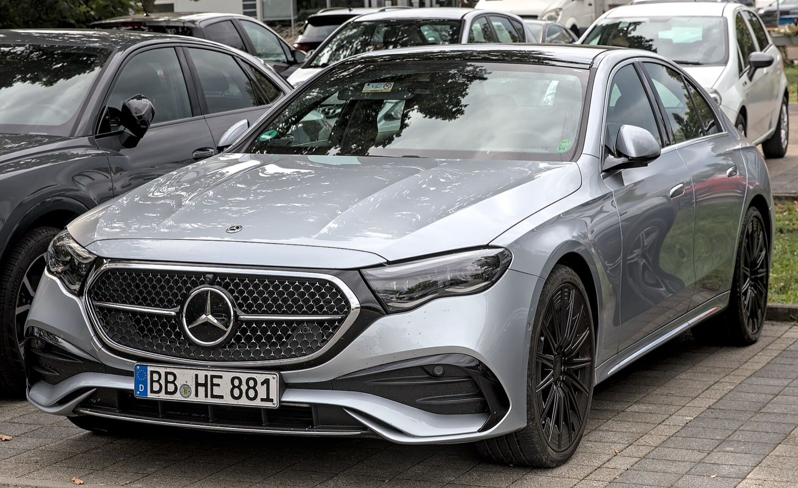 Silver Mercedes-Benz E-Class (W214) sedan, front three-quarter view
