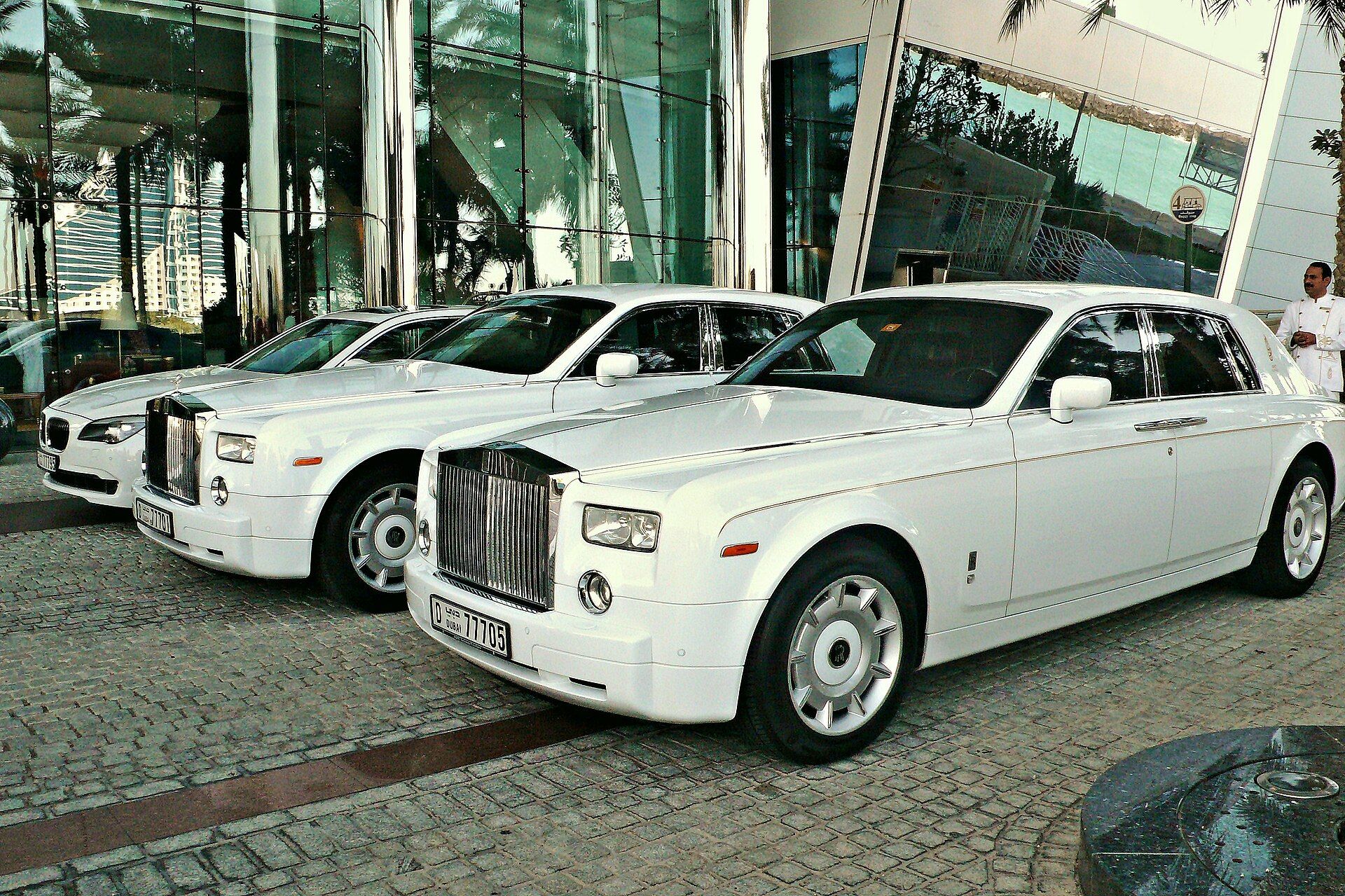 White Rolls Royce Phantom limousines parked outside a hotel entrance in Dubai