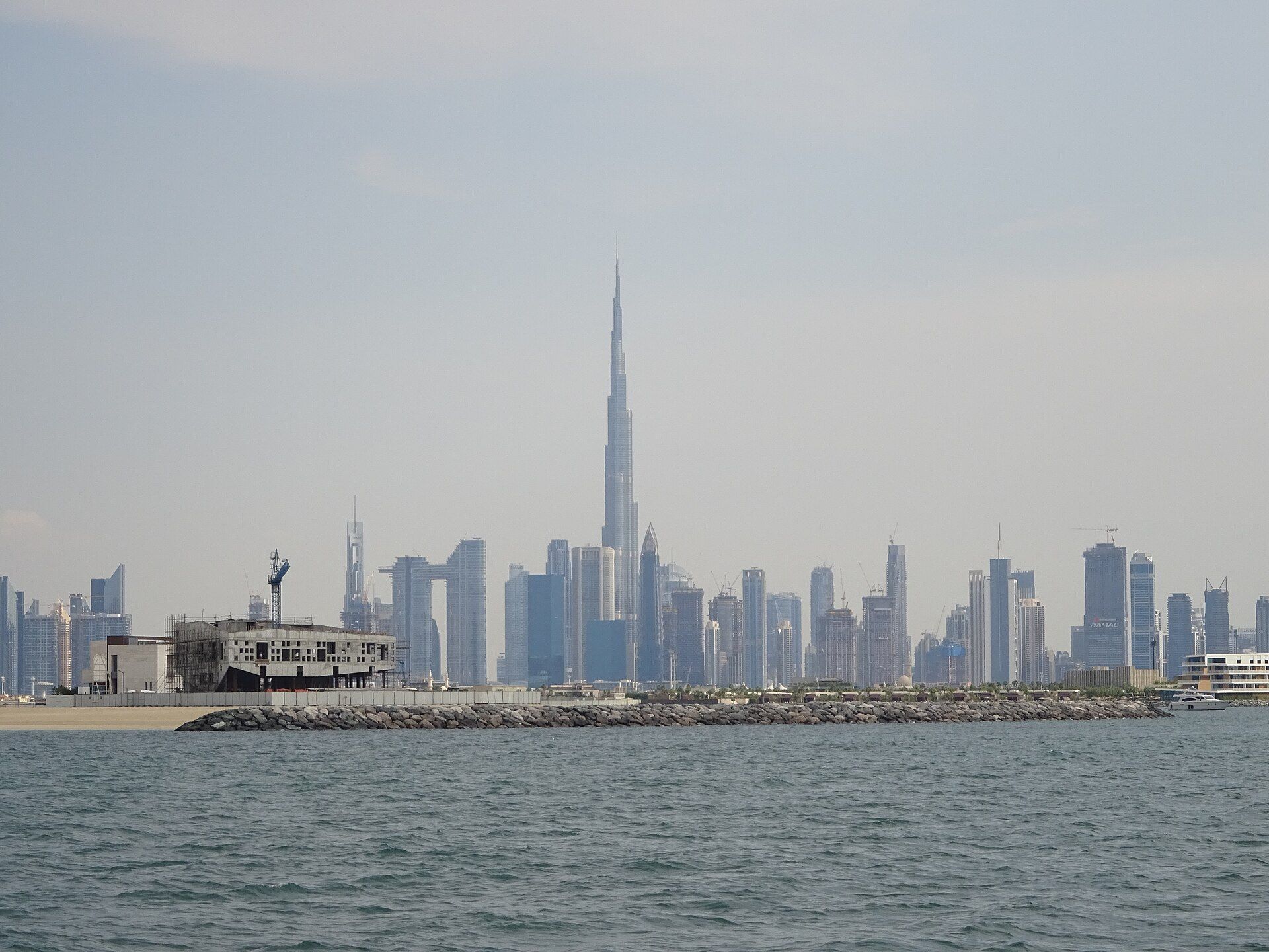 Burj Khalifa rising above the Dubai skyline, seen from a ferry off the Dubai coast